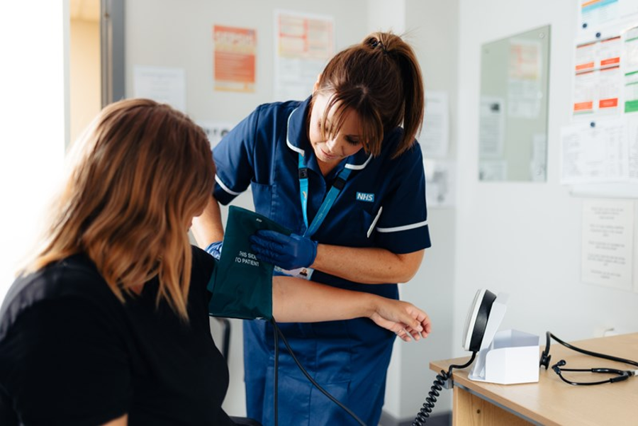 An image of a nurse treating a patient in a GP Practice