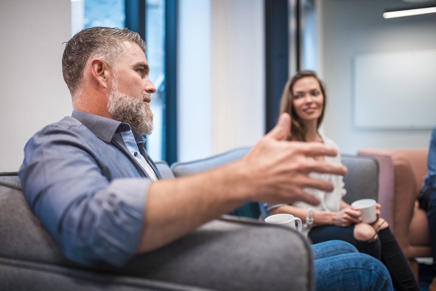 A man talking and a woman listening stock image