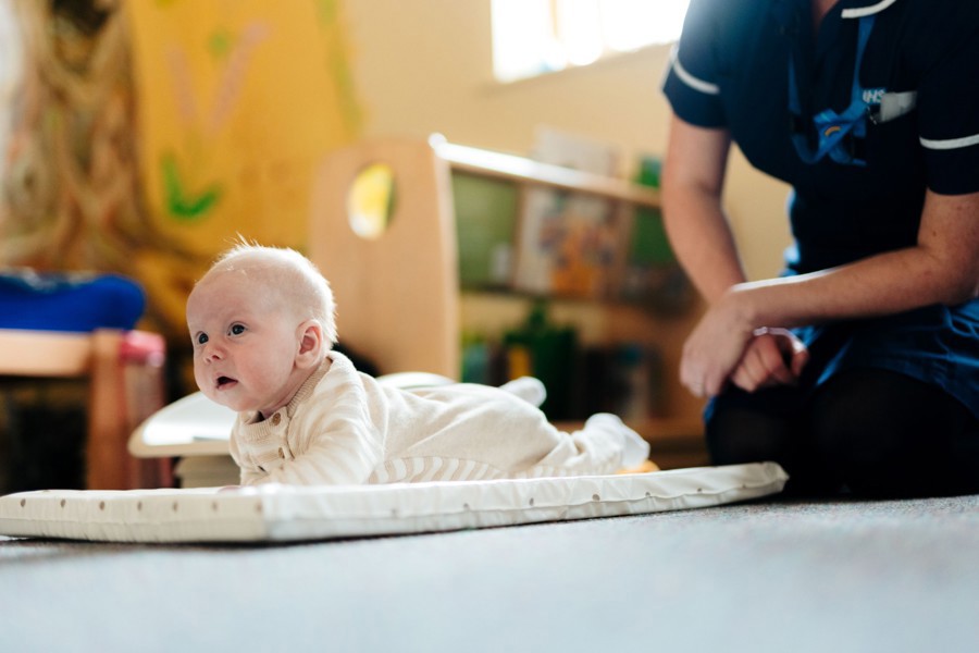 A picture of a baby with a nurse